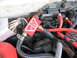1992 Dodge Stealth - A close-up view of engine bay components, including hoses and electrical connectors, with a red part a white logo.