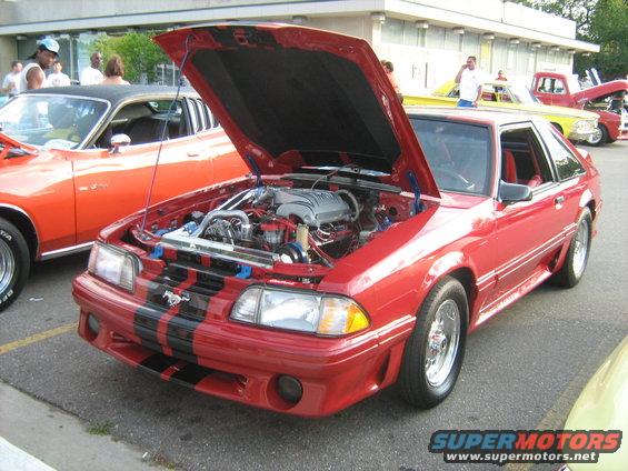 Red 1988 Ford Mustang GT with black stripes and hood open