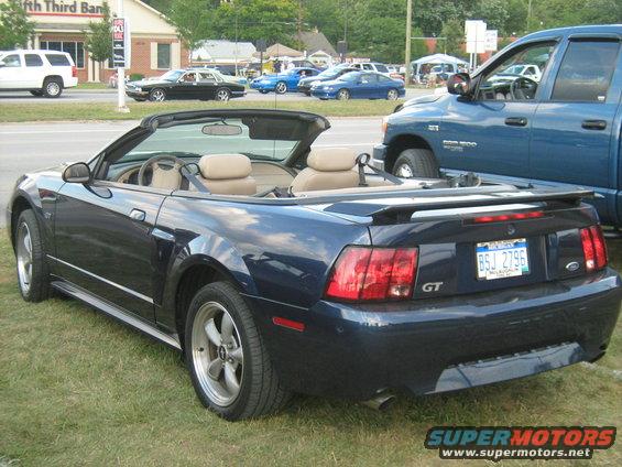 Blue convertible sports car with GT badging and a license plate reading BSJ 2796
