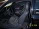 1989 Mazda MX-6 - The interior of a 1989 Mazda MX-6 features gray leather seats, a dark dashboard, and a glimpse of the steering wheel and gauges.
