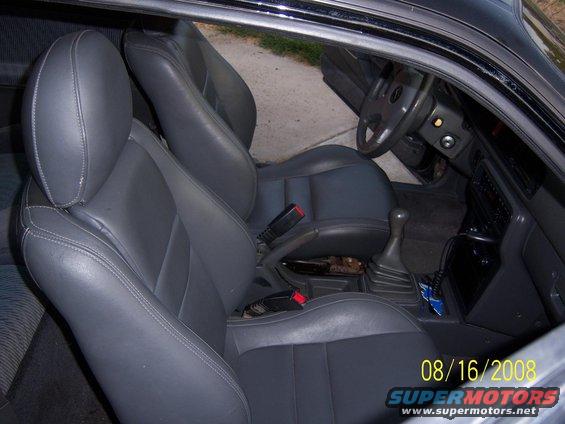 Interior view of car seats, dashboard, and steering wheel