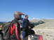 2008 Honda RANCHER - Two men and their ATVs are stopped on a rocky mountain trail under a clear blue sky.