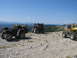 2008 Honda RANCHER - Multiple ATVs are parked on a rocky mountain ridge under a clear blue sky.