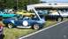 2003 Ford Crown Victoria - Several classic cars are on display at an outdoor event, with a focus on two Shelby Cobra replicas.