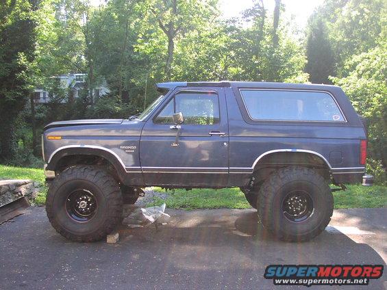 1986 Ford Bronco lifted with large off-road tires, side view