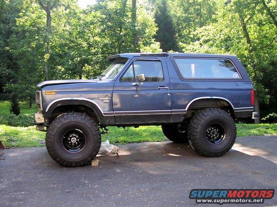 1986 Ford Bronco lifted with large off-road tires, side view