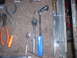 1992 Ford Bronco - A collection of various hand tools, including ratchets, pliers, and wrenches, laid out on a carpeted surface.