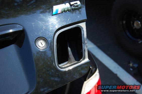 2002 BMW M3 emblem and fuel filler door on black car