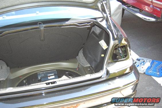 2002 BMW M3 trunk open, taillight removed, tools nearby