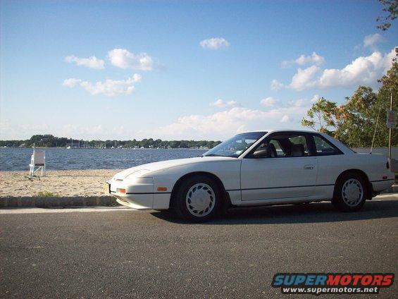 White Nissan 240SX parked by the water