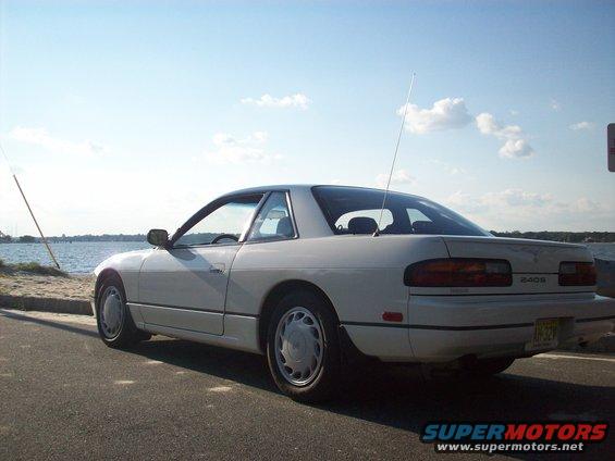 White 1990 Nissan 240SX coupe parked by the water, rear view