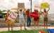 1992 Ford Mustang - A group of people are gathered outdoors, holding up various signs.