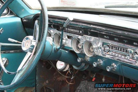 Teal interior dashboard with chrome accents and a vintage radio