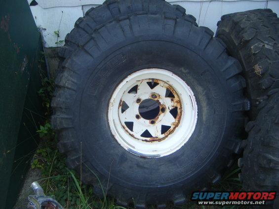 Tire and white wheel with rust, close-up