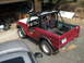 1968 Ford Bronco - A red 1968 Ford Bronco is parked in a garage, appearing to be undergoing some work or restoration.