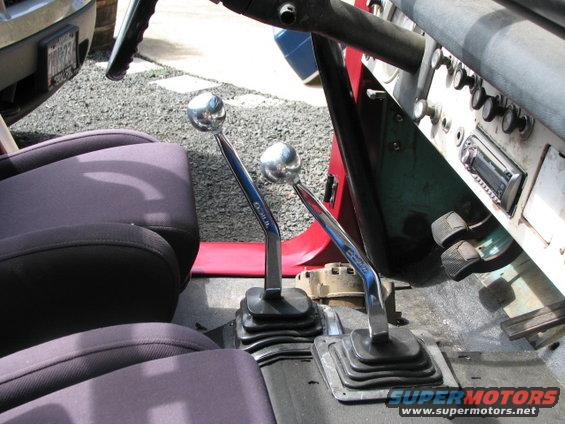 1968 Ford Bronco interior showing two chrome shifters and bucket seats