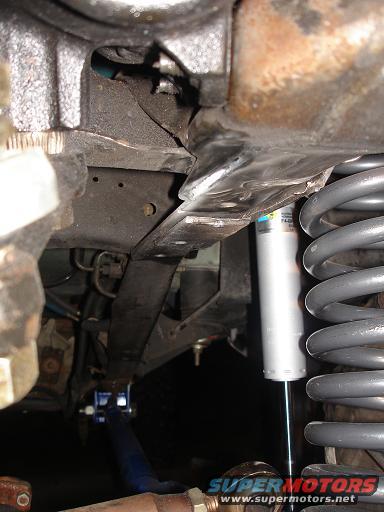 Vehicle suspension with shock absorber, coil spring, and leaf spring.