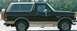 1988 Ford Bronco - This 1988 Ford Bronco is seen from the side, a two-tone black and tan paint scheme and a rear-mounted spare tire.