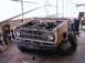 1971 Ford Bronco - Front view of a 1971 Ford Bronco undergoing restoration, engine exposed.
