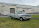 1969 Ford F-250 - This classic Ford F-Series pickup truck is parked outside a large industrial building.