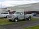 1969 Ford F-250 - A gray 1967 Ford F-250 pickup truck is parked outside a large building with other vehicles nearby.
