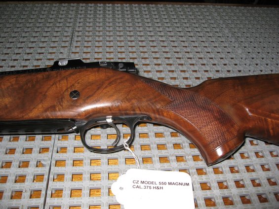 Close-up of a CZ Model 550 Magnum rifle's wooden stock and trigger assembly