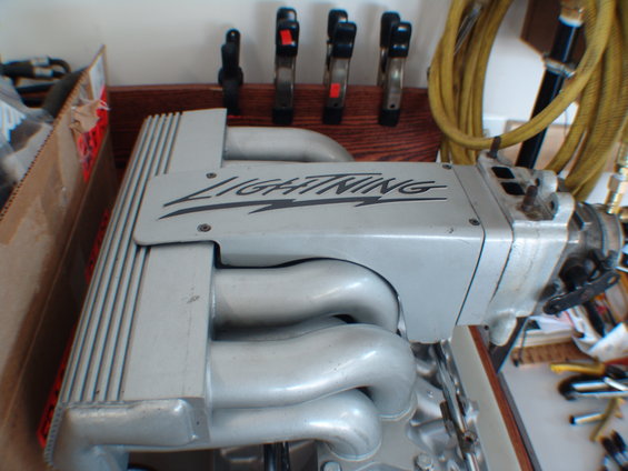 Ford Lightning supercharger and intake manifold assembly. Tools and a yellow hose are visible in the background