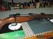 1991 Ford Bronco - A rifle with a wooden stock and metallic bolt action is displayed on a Swarovski Optik mat, with boxes of ammunition in the background.