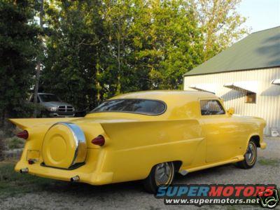 1953 Ford Mainline custom sedan, yellow, with continental kit and fins