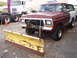 1979 Ford Bronco - A weathered Ford Bronco, likely from the late 1970s, is equipped with a front-mounted snow plow.