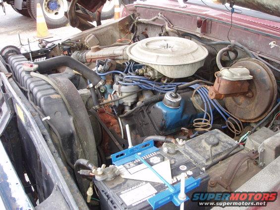 Engine bay with V8 engine, air cleaner, radiator, and battery