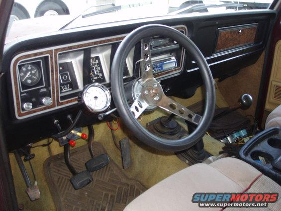 1979 Ford Bronco interior showing dashboard, steering wheel, pedals, and shifter