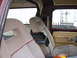 1979 Ford Bronco - The interior of a vehicle is shown, with a view of a trailer through the side window.