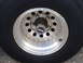 1979 Ford Bronco - A close-up view of a vehicle's wheel and tire, a WARN branded hubcap.