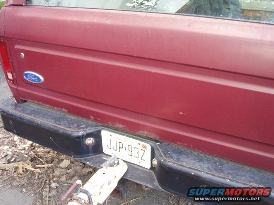 Rear view of a red 1979 Ford Bronco showing the tailgate, Ford emblem, and license plate JJP-93Z