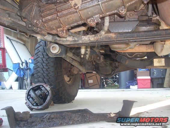 Disassembled transfer case and differential next to a vehicle's undercarriage