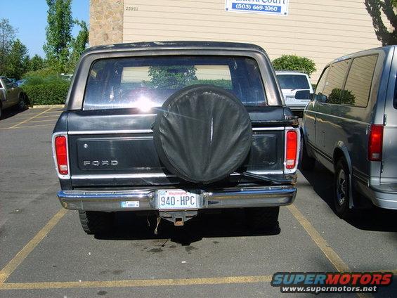 Black 1978 Ford Bronco rear view with spare tire cover and chrome bumper