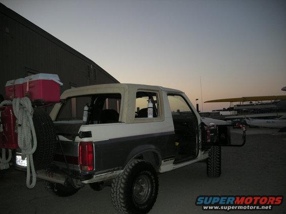 1991 Ford Bronco with soft top, spare tire, and coolers on rear carrier