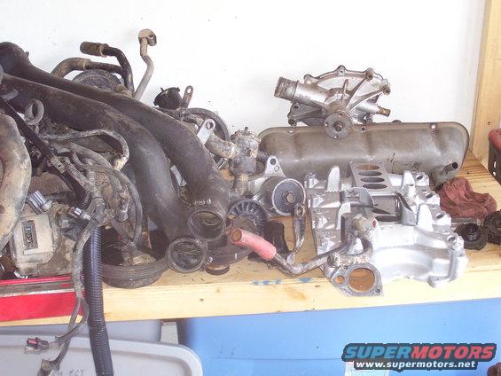 Engine parts including intake manifold, valve cover, and water pump