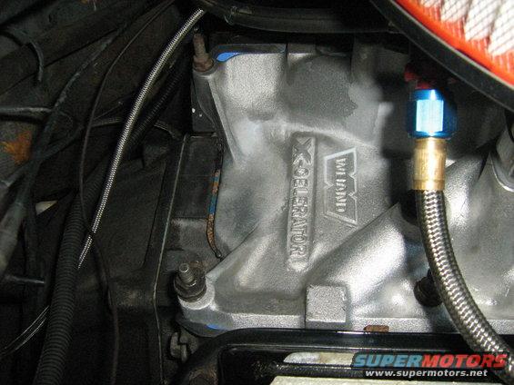 Close-up of a Weiand X-CELerator intake manifold with braided hose attached