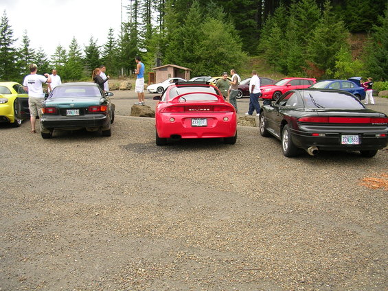 Red Mitsubishi Eclipse with a large rear spoiler and a license plate reading "433-BHT"