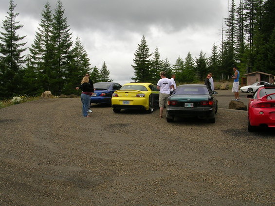Yellow Mazda RX-8 rear view with other cars and people