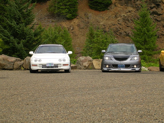 White Acura Integra and gray Mazda 3 parked side-by-side