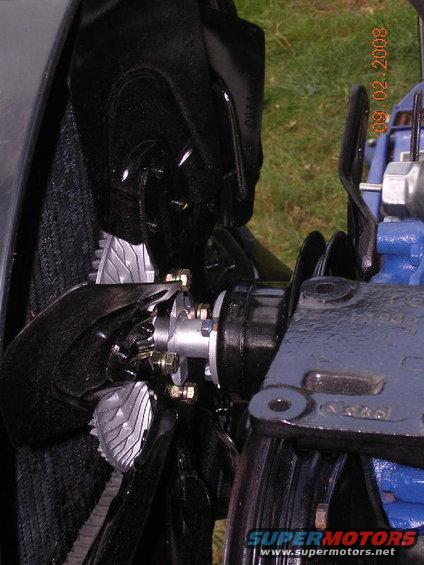 Engine fan and radiator assembly with blue engine block visible