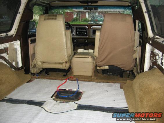 1979 Ford Bronco interior showing removed floor insulation and exposed wiring