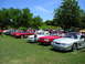 2009 Ford Mustang - A collection of Ford Mustangs are gathered outdoors on a sunny day.