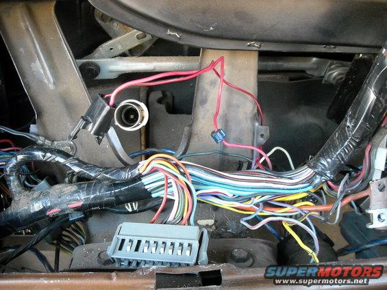 Close-up of a tangled vehicle wiring harness with many colored wires and connectors