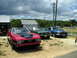 2009 Ford Mustang - A trio of vintage Ford Mustangs are gathered outside a building, possibly for a car club event.