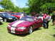 2009 Ford Mustang - A group of Mustangs are gathered outdoors on a sunny day.