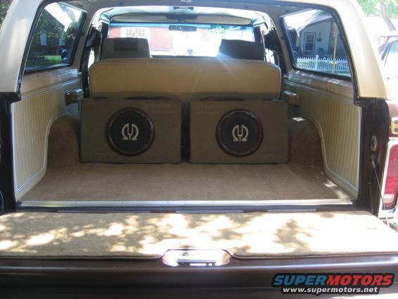 Back of an SUV with two subwoofers installed behind the rear seat